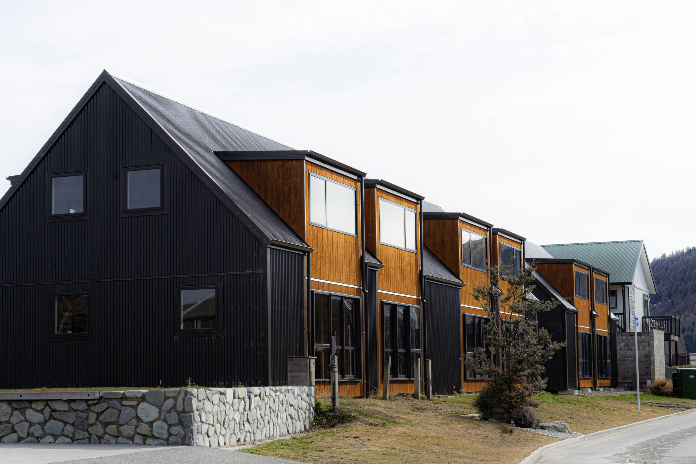 Row of mountain-modern homes on a residential street