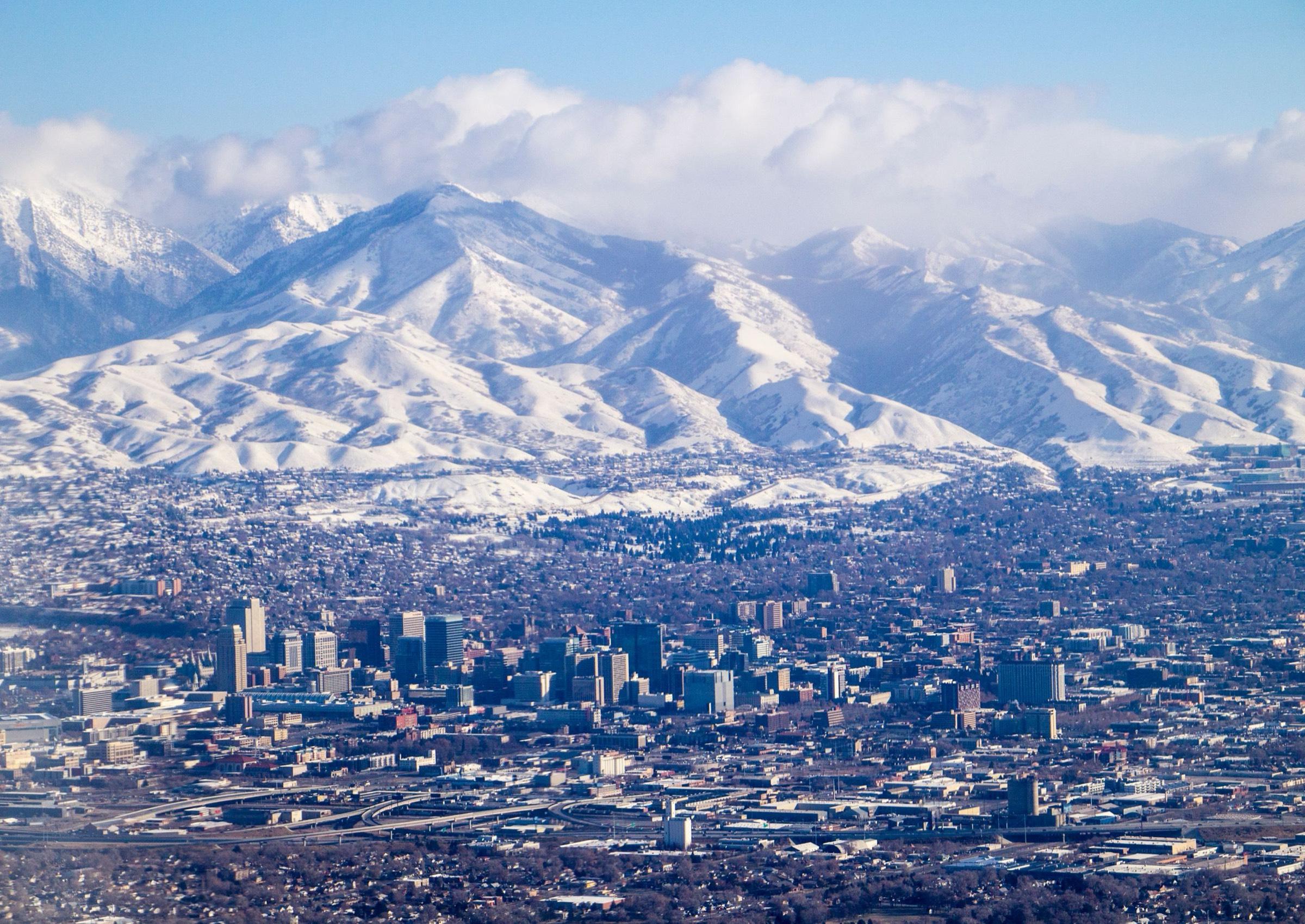 Residential neighborhoods across the Salt Lake Valley with the Wasatch Mountains rising in the background